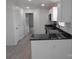 Bright kitchen featuring white cabinetry, black countertops, and stainless steel appliances at 8027 Bristle Ln, Charlotte, NC 28214