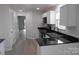 Bright kitchen featuring white cabinetry, black countertops, and stainless steel appliances at 8027 Bristle Ln, Charlotte, NC 28214