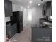 Modern kitchen with dark cabinets and granite countertops at 8027 Bristle Ln, Charlotte, NC 28214