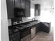 Modern kitchen with dark cabinets and granite countertops at 8027 Bristle Ln, Charlotte, NC 28214