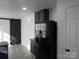 Modern kitchen with black appliances and barn door at 8027 Bristle Ln, Charlotte, NC 28214