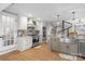 Modern kitchen featuring a farmhouse sink, stainless steel appliances, and an island at 8478 Rocky River Rd, Harrisburg, NC 28075