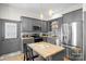 Modern kitchen featuring gray cabinets, stainless steel appliances, and a butcher block island at 8478 Rocky River Rd, Harrisburg, NC 28075