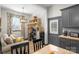 Charming kitchen with gray cabinets, butcher block countertops, and modern appliances at 8478 Rocky River Rd, Harrisburg, NC 28075