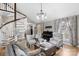 Spacious living room with hardwood floors, spiral staircase, and large windows at 8478 Rocky River Rd, Harrisburg, NC 28075