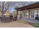 Brick patio with covered seating area and fireplace at 8478 Rocky River Rd, Harrisburg, NC 28075