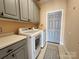 Bright laundry room, featuring washer, dryer, and ample cabinetry at 901 Huntington Hills Dr, Lincolnton, NC 28092