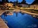 Stunning pool at night with pergola and string lights at 901 Huntington Hills Dr, Lincolnton, NC 28092