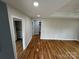 The primary bedroom features hardwood floors, closet, and windows at 112 Mccray Ave, Kannapolis, NC 28081