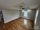 Spacious bedroom with hardwood floors, a modern ceiling fan, and plenty of natural light at 112 Mccray Ave, Kannapolis, NC 28081