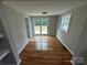 Sunlit dining area with sliding glass doors leading to an outdoor deck and hardwood floors at 112 Mccray Ave, Kannapolis, NC 28081