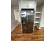 Close-up of the stainless steel refrigerator with storage, hardwood floors, and neutral paint at 112 Mccray Ave, Kannapolis, NC 28081