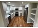Bright kitchen features white cabinets, quartz countertops, stainless steel appliances, and hardwood floors at 112 Mccray Ave, Kannapolis, NC 28081