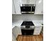 Updated kitchen features stainless steel oven, microwave, white cabinets, and quartz counters at 112 Mccray Ave, Kannapolis, NC 28081