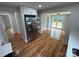 Bright kitchen featuring stainless steel refrigerator, hardwood floors and view of dining area at 112 Mccray Ave, Kannapolis, NC 28081