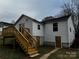 Rear of house features a new wooden deck, white siding, and updated windows at 112 Mccray Ave, Kannapolis, NC 28081
