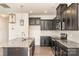 Modern kitchen with dark cabinetry, granite island, and stainless steel appliances at 1218 Raelea Dr, Indian Trail, NC 28079