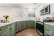 Modern kitchen with green cabinets and white tile backsplash at 17440 Tuscany Ln, Cornelius, NC 28031