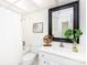 Clean bathroom with white vanity, bathtub, and large framed mirror at 2610 Tattersall Dr, Charlotte, NC 28210