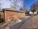 Brick home exterior with driveway and partial view of backyard at 2610 Tattersall Dr, Charlotte, NC 28210