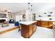 Open kitchen with island, white quartz countertops, and dark wood cabinets at 2610 Tattersall Dr, Charlotte, NC 28210