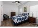 Bedroom with a blue and white star quilt, wooden dresser, and blue chair at 112 Canina Ln, Indian Trail, NC 28079