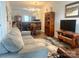 Open floor plan living and dining area with gray couch and wooden dining table at 112 Canina Ln, Indian Trail, NC 28079