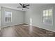 Bedroom with ceiling fan, two windows with blinds, and wood-look flooring at 116 E Maryland Ave, Bessemer City, NC 28016