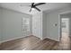 Bedroom with ceiling fan, double-door closet, and wood-look flooring at 116 E Maryland Ave, Bessemer City, NC 28016