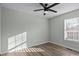 Bright bedroom with ceiling fan, wood-look flooring, and a window with blinds at 116 E Maryland Ave, Bessemer City, NC 28016