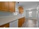 Eat-in kitchen with wood cabinets, a view of the dining area, and new appliances at 116 E Maryland Ave, Bessemer City, NC 28016