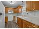 Galley kitchen with wood cabinets and modern appliances at 116 E Maryland Ave, Bessemer City, NC 28016