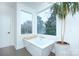 Modern bathroom with a freestanding tub and large window at 1220 Lomax Ave, Charlotte, NC 28211