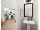 Small powder room with pedestal sink and a framed mirror at 13114 Blacksmith Ct, Matthews, NC 28105