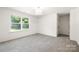 Simple bedroom with large window and plush carpet at 13114 Blacksmith Ct, Matthews, NC 28105