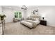 Main bedroom with plush carpet, a king-size bed and an ensuite bathroom at 13114 Blacksmith Ct, Matthews, NC 28105