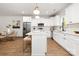 Bright kitchen featuring white cabinets, an island, and stainless steel appliances at 13114 Blacksmith Ct, Matthews, NC 28105