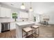 Modern kitchen with white cabinets, island, and stainless steel appliances at 13114 Blacksmith Ct, Matthews, NC 28105