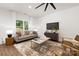 Living room featuring hardwood floors, a comfortable sofa, and large window at 13114 Blacksmith Ct, Matthews, NC 28105