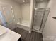 Modern bathroom featuring a bathtub, shower, and vanity with neutral countertops at 1608 Cole St, Gastonia, NC 28054