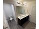 Bathroom featuring double sinks, a large mirror, and sleek finishes at 1608 Cole St, Gastonia, NC 28054