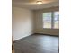 Spacious bedroom with neutral walls, wood-look flooring, and a large window at 1608 Cole St, Gastonia, NC 28054