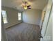 A spacious carpeted bedroom with ceiling fan and large windows at 1608 Cole St, Gastonia, NC 28054