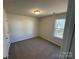 A bedroom with neutral walls, plush carpet, and a window providing natural light at 1608 Cole St, Gastonia, NC 28054