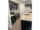 Modern kitchen with dark cabinets, granite countertops, and stainless steel appliances at 1608 Cole St, Gastonia, NC 28054