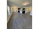 Open-concept living room flowing to kitchen, featuring lots of natural light and wood floors at 1608 Cole St, Gastonia, NC 28054