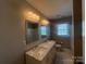 Bright bathroom with dual sinks, marble countertop, and large mirror at 1907 Steele St, Monroe, NC 28110