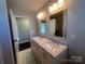 Bright bathroom featuring a double vanity with granite countertop, undermount sinks, and modern fixtures at 1907 Steele St, Monroe, NC 28110