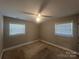 Neutral bedroom featuring carpet, a ceiling fan, and two windows at 1907 Steele St, Monroe, NC 28110