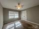 Cozy bedroom with neutral carpet, ceiling fan, and natural light from the window at 1907 Steele St, Monroe, NC 28110